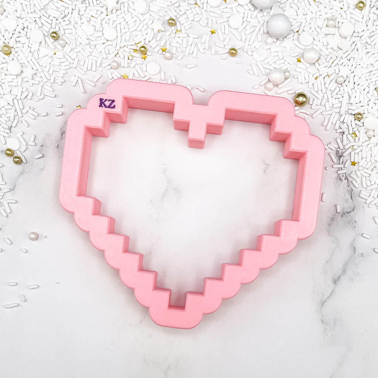 cookie cutter in the shape of a pixelated heart 
