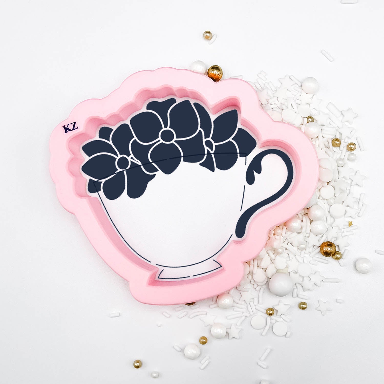 Cookie cutter in the shape of a teacup with flowers in it