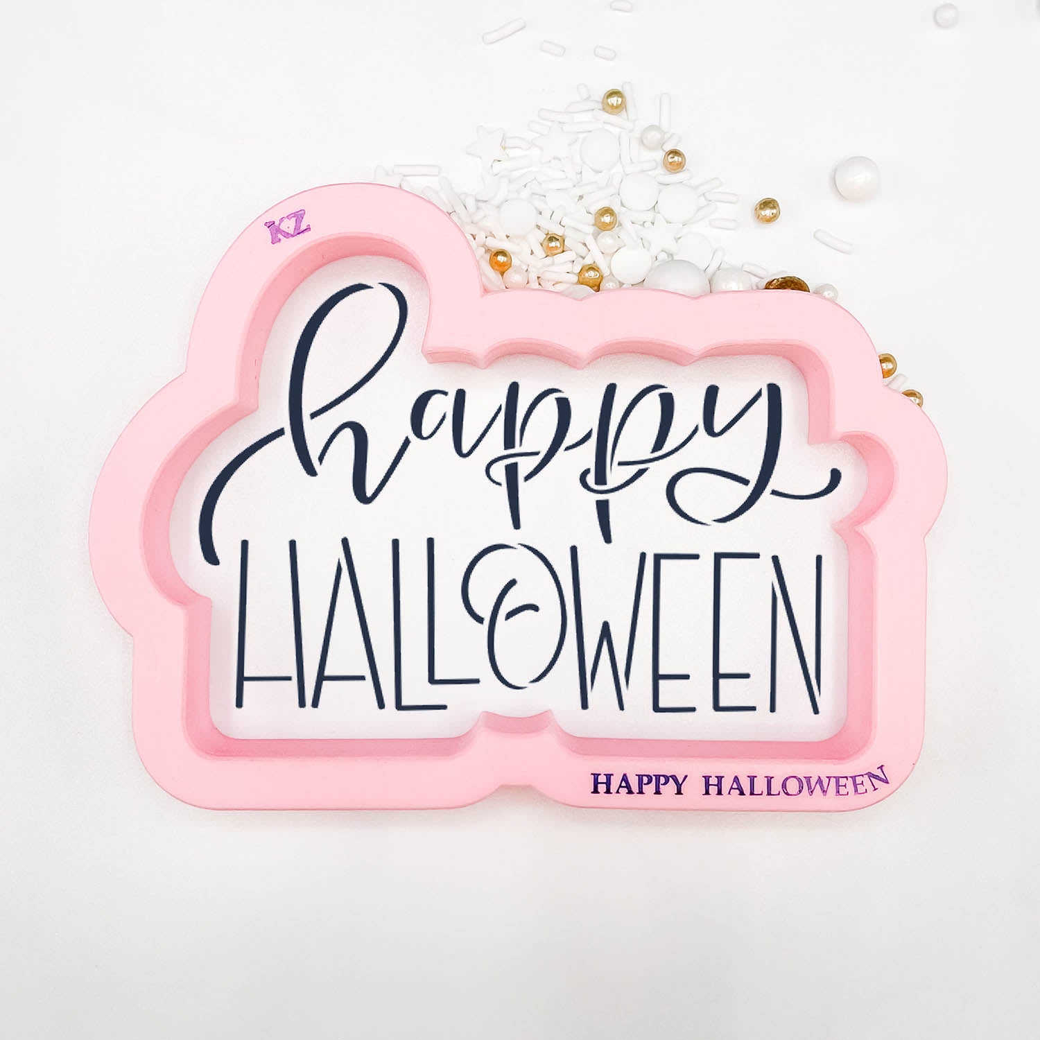 cookie cutter in the shape of the words "happy halloween"