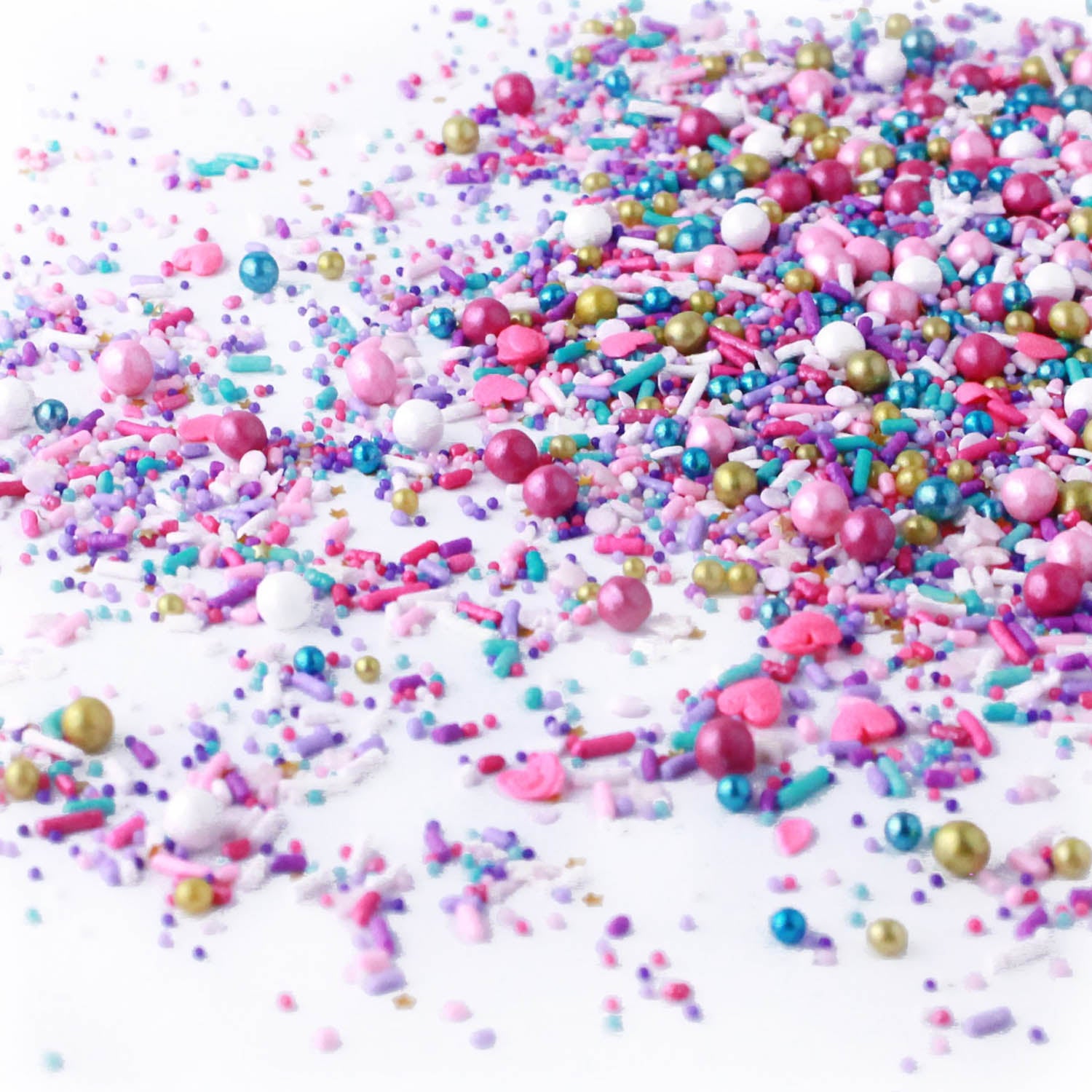 Sprinkle mix with light and dark pink, gold, blue, and white spheres and rods. Same colors as smaller sprinkle pieces.